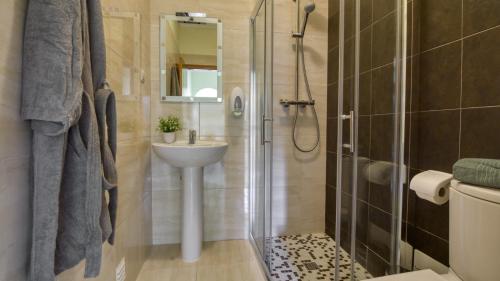a bathroom with a shower and a sink and a toilet at 8-Bed Villa in Vilamoura-Sleeps-Playground-Pool in Vilamoura