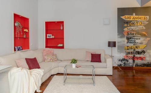 a living room with a white couch and a table at 8 HOME in Rome