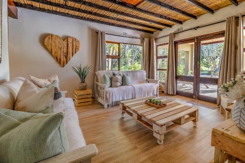 a living room with a couch and a coffee table at Wilderness Metanoia in Wilderness