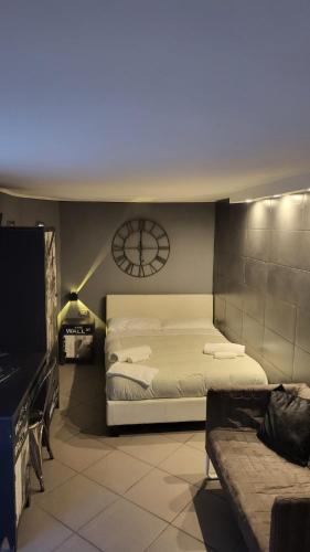 a bedroom with a bed and a clock on the wall at Il Taschino Suite in Naples