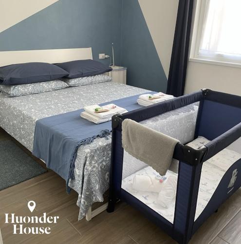 a bedroom with a bed with towels on it at Huonder House in Lecco