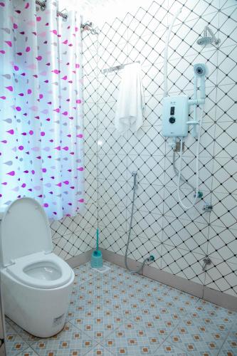 a bathroom with a toilet and a shower at Africa Guest House in Mbarara