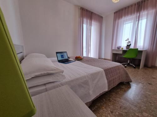 a bedroom with a bed with a laptop on it at Appartamento al Centro Storico di San Marino in San Marino