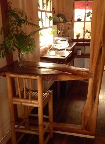 a kitchen with a wooden table with a mirror at Casa Lumière in Bocas del Toro