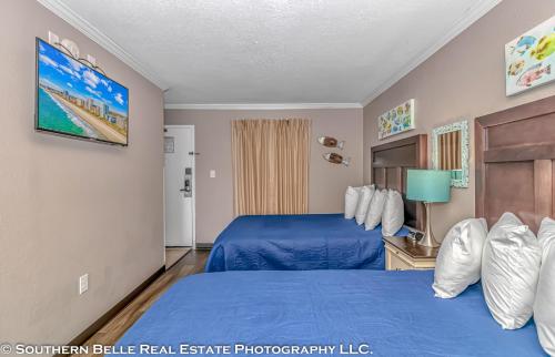 a bedroom with a blue bed in a room at Ocean View Double Suite with Beautiful Decor and Accents Caravelle Resort 1504 Sleeps 6 Guests in Myrtle Beach