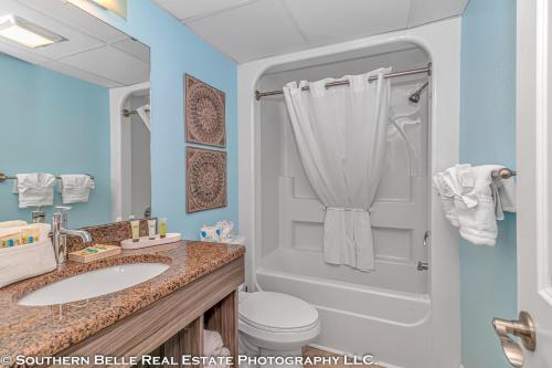 a bathroom with a sink and a shower and a toilet at Ocean View Double Suite with Beautiful Decor and Accents Caravelle Resort 1504 Sleeps 6 Guests in Myrtle Beach