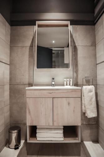 a bathroom with a sink and a mirror at Cascades Guest Lodge in Nelspruit