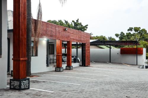 a parking lot in front of a brick building at Cascades Guest Lodge in Nelspruit