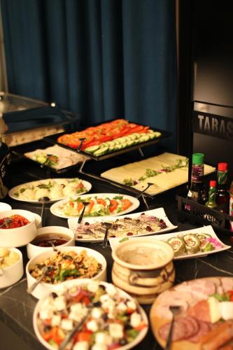 a table topped with lots of different types of food at Arboretum Hotel in Wolbórz