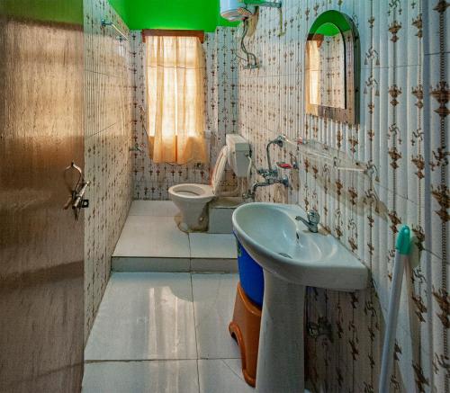 a bathroom with a sink and a toilet at 3 Sisters' Homestay in Ravangla