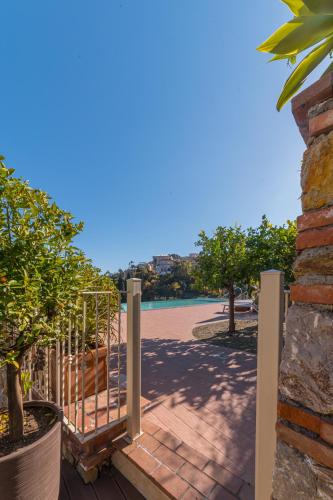 a wooden gate leading to a beach with trees at Taormina Skyline in Taormina