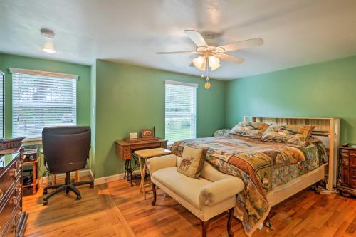 a bedroom with a bed and a chair and a ceiling fan at Carrabelle Home Near River, Beach and Downtown! in Carrabelle