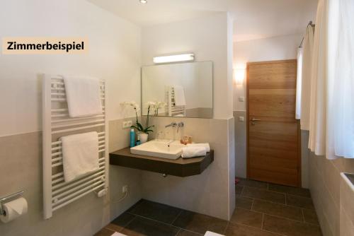 a bathroom with a sink and a mirror at Hotel-Gasthof Mauthäusl in Weißbach