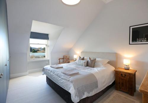 a bedroom with a large bed and a window at The Botanics Residence in Edinburgh