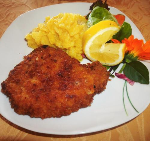a white plate of food with scrambled eggs and vegetables at Adam & Eva Gasthof Paradies mit Hotel in Vogt