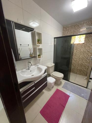 a bathroom with a sink and a toilet and a shower at Casa deck caixa d´aço in Porto Belo
