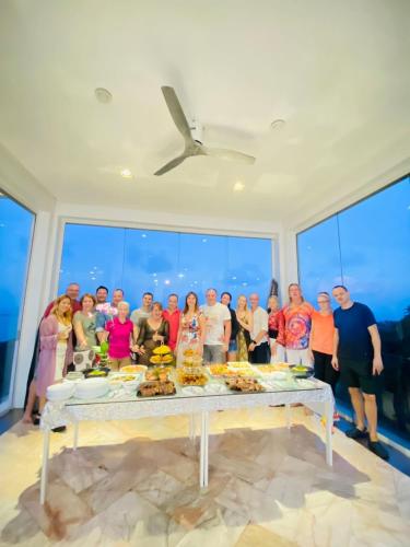 a group of people standing around a table with food at Best world vision in Chaweng