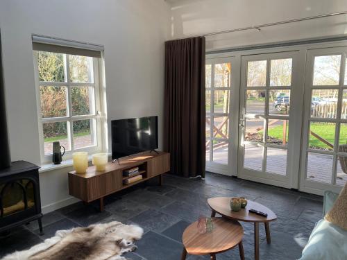 a living room with a dog laying on the floor at B&B De Porrel in Polsbroek