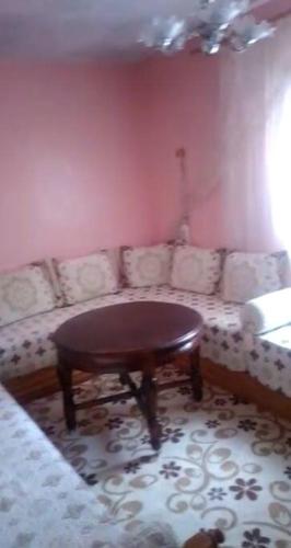 a living room with a couch and a table at location nuit pour les familles in Settat