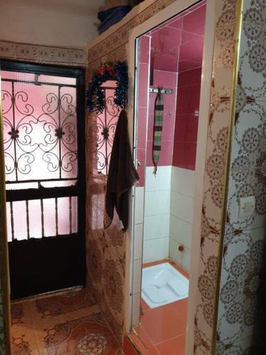 a bathroom with a shower and a toilet and a window at location nuit pour les familles in Settat