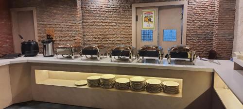 a bunch of plates sitting on a counter in a kitchen at Raj Darbar - 10 Meter From Golden Temple in Amritsar