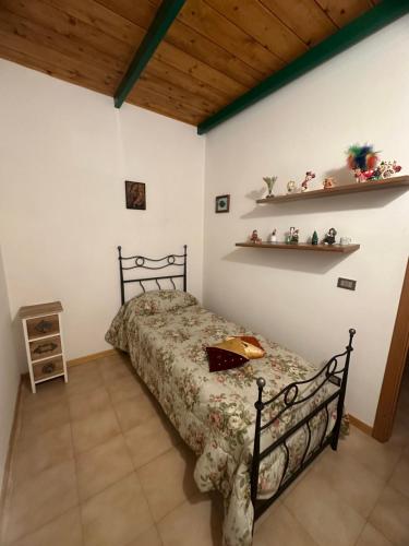 1 dormitorio con cama y techo de madera en Relax home en San Massimo