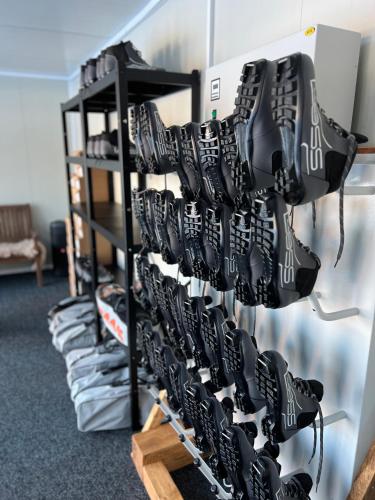 a bunch of shoes on a rack in a room at Resort Pasecna in Přední Výtoň