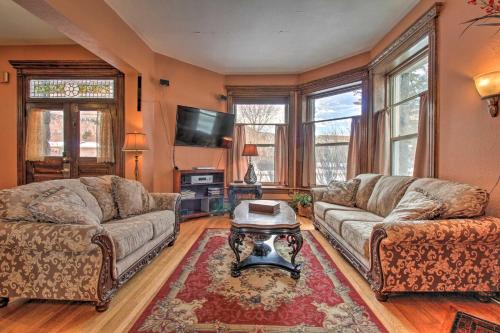 a living room with two couches and a tv at Historic Helena Home with Mtn Views - 2 Mi to Dtwn! in Helena