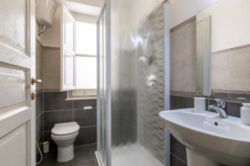 a bathroom with a sink and a toilet and a shower at Teatro Massimo Bright and Cozy Apartment in Palermo