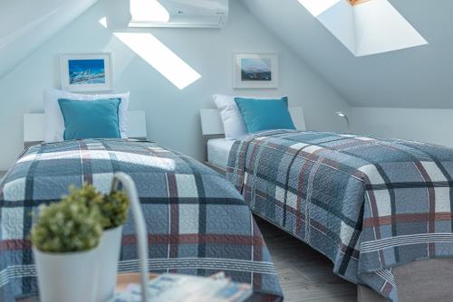 2 camas en una habitación con paredes azules en Apartament Widok 5, en Piechowice