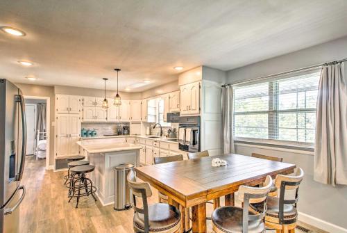 a large kitchen with a wooden table and chairs at Lakeview Home - 1 Mile from Bull Shoals Lake! in Bull Shoals