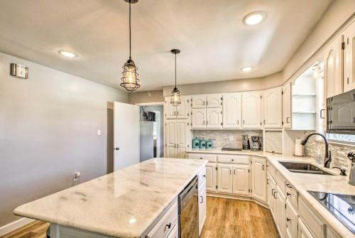 a kitchen with white cabinets and a large island at Lakeview Home - 1 Mile from Bull Shoals Lake! in Bull Shoals