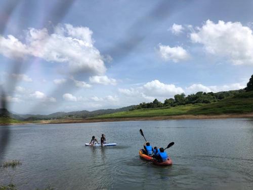 a group of people on a river in a kayak at Randeniya Hena in Teldeniya