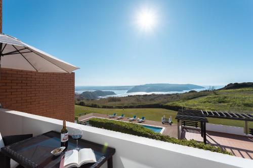 a balcony with a table and a view of the ocean at Azure - Vista para o Oceano by Smarthomes in São Martinho do Porto