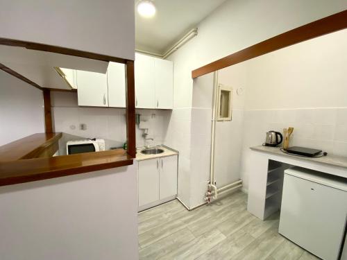 a kitchen with white cabinets and a counter top at Grand Royal in Belgrade