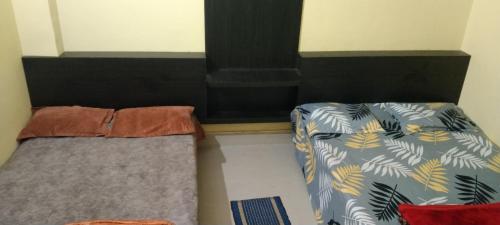 two beds sitting next to each other in a room at NEW MILAN PALACE, Deoghar in Deoghar
