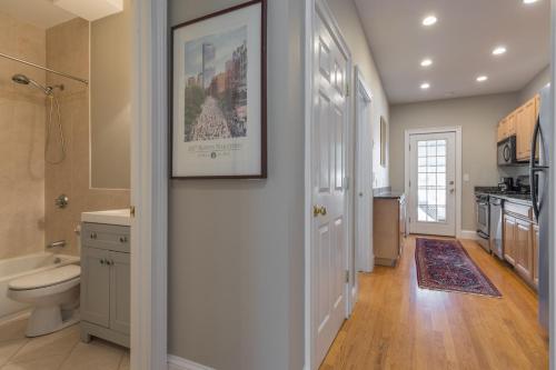 a bathroom with a toilet and a sink at Sunny convenient home w/ private patio! Easy walk to everything! in Boston