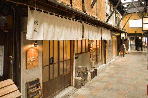 an empty street in a building with a sign on it at Toyooka guesthouse Hostel Act in Toyooka