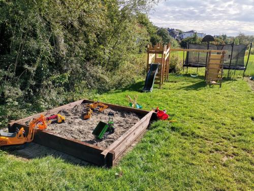 a sandbox in a yard with some toys in it at Franzl Hof Zorell in Ravensburg