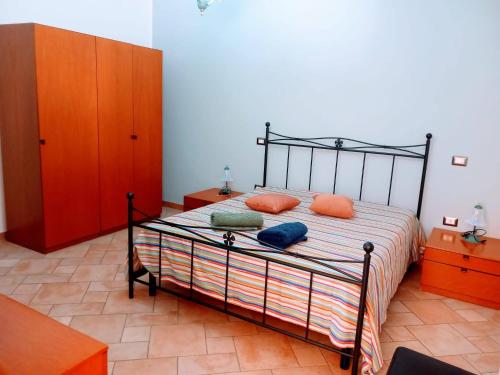 a bedroom with a bed with orange pillows on it at Casa Margherita in Nebida