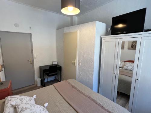 a bedroom with a bed with a tv on top of it at Les Merisiers B&B - Thorenc in Thorenc