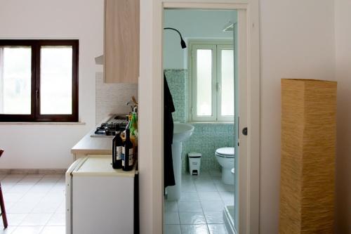 a kitchen with a sink and a toilet in a room at 8380 Il Glicine in Albinia