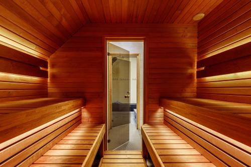a sauna with wooden walls and wooden flooring at Aida Apartment in Külitse