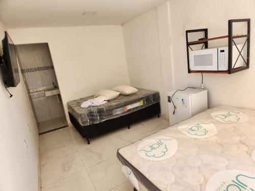 Una cama o camas en una habitación de POUSADA FLOR DO CARIBE