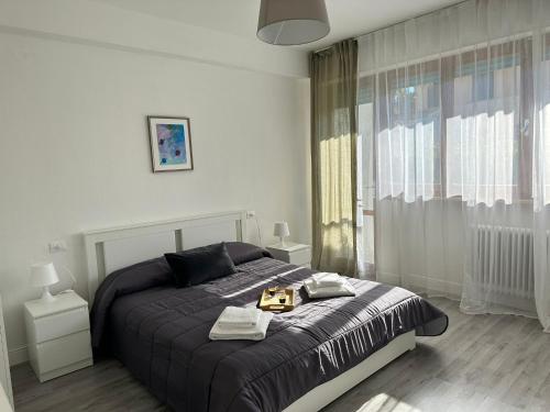 a bedroom with a bed with a tray on it at Appartamento VN House in Pisa