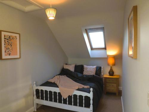 a small bedroom with a crib in a attic at Quiet Country Annex - Near M1 - J27 in Selston