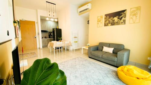 a living room with a couch and a table at The Icon2 Condo in IOI City Mall Putrajaya, Pool View in Putrajaya