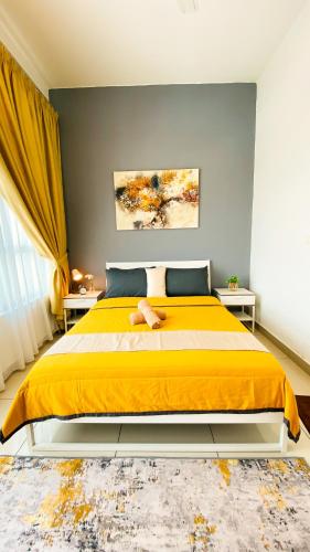 a bedroom with a large bed with a yellow blanket at The Icon2 Condo in IOI City Mall Putrajaya, Pool View in Putrajaya