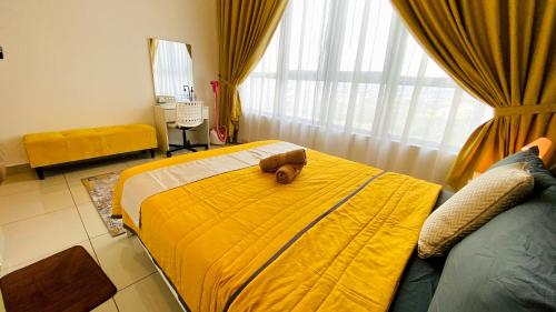 a bedroom with a large bed with a yellow blanket at The Icon2 Condo in IOI City Mall Putrajaya, Pool View in Putrajaya