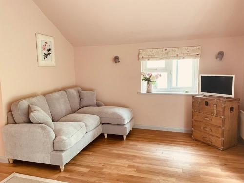 a living room with a couch and a television at Meadow View in Mayfield